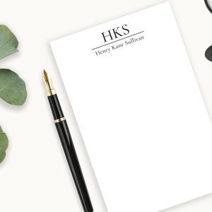 May include: A white notepad with a black border and the text "HKS Henry Kane Sullivan" at the top.