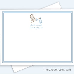 May include: A blue and white stork carrying a blue baby bag with the text "from the nursery of JASON BARNES" on a white card with a blue border.
