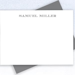 May include: A white stationery card with the name "SAMUEL MILLER" printed in black at the top.