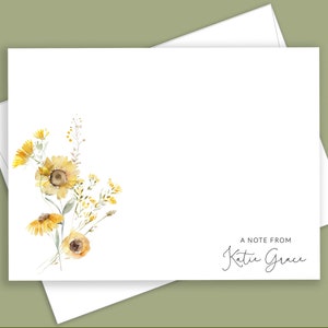 May include: A white card with a watercolor illustration of yellow flowers and the text "A note from Katie Grace".