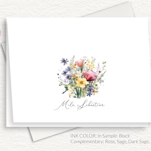 May include: A white card with a watercolor illustration of a bouquet of pink, yellow, and blue flowers. The text "Mile Lebretion" is written in cursive at the bottom of the card. The text "INK COLOR: In Sample: Black Complementary: Rose, Sage, Dark Sage, Marine" is written at the bottom of the card.