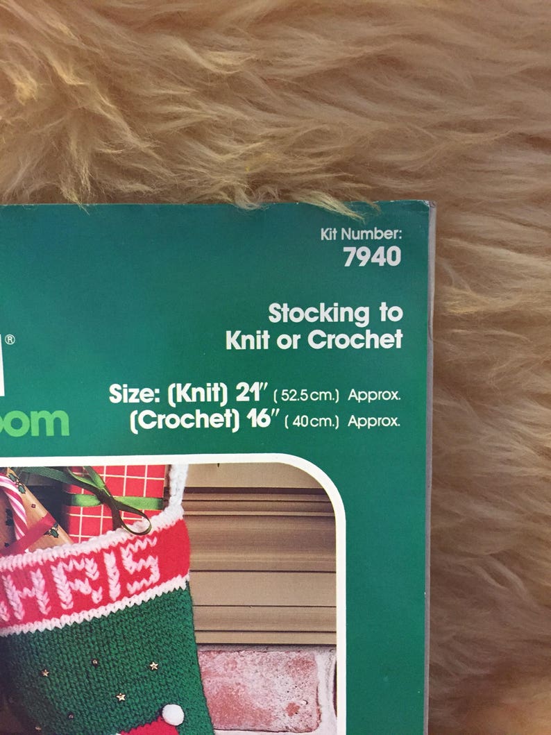 May include: A green and red Christmas stocking with the word "CHRIS" knitted in white on the front. The stocking is 21 inches long when knitted and 16 inches long when crocheted. The kit number is 7940.