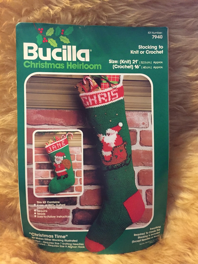 May include: A Bucilla Christmas Heirloom kit for knitting or crocheting a green and red stocking with a Santa Claus design. The kit includes yarn, sequins, beads, and instructions. The stocking is 21 inches long when knitted and 16 inches long when crocheted.