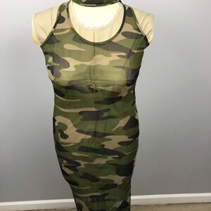 May include: A long, sleeveless, sheer, camouflage print maxi dress. The dress is made of a lightweight, breathable fabric and has a relaxed fit.