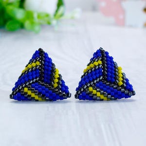 May include: A set of three ceramic mugs with a speckled, matte finish in cream, light grey, and dark grey. Each mug has a simple, minimalist design, suitable for coffee or tea.