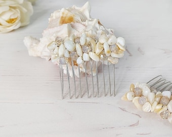 May include: Two hair combs featuring silver-toned metal teeth and decorative tops adorned with clusters of small, polished white and beige stone chips. The stones are arranged in a dense, textured pattern across the top of each comb.