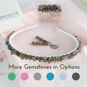 May include: A white headband, comb, and earrings set with gray and gold gemstones. The set includes a comb, a headband, and a pair of earrings. The text "More Gemstones in Options" is visible.