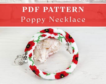 May include: A beaded necklace featuring a white background with red poppy flowers and green stems. The text PDF PATTERN Poppy Necklace is displayed at the top. The necklace has a silver-toned metal clasp with a flower-shaped charm attached.