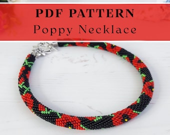 May include: A beaded necklace featuring a spiral pattern of red, black, and green seed beads. The text PDF PATTERN Poppy Necklace is displayed above the jewellery. A silver-toned metal flower-shaped clasp secures the circular beaded strand.