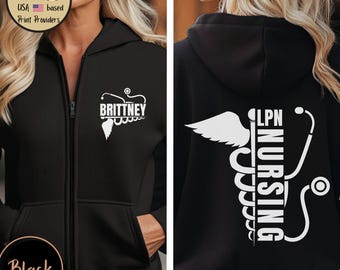 May include: A black zip-up hoodie featuring a white graphic on the front left chest with the name Brittney and a stethoscope design. The back displays a large white graphic of a caduceus symbol with a stethoscope and the text LPN NURSING.