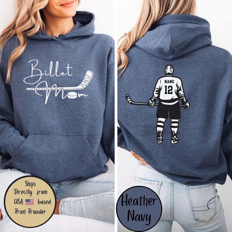 May include: Heather navy blue hoodie with a front graphic that says "Billet Mom" with a hockey stick and puck. The back of the hoodie features a hockey player graphic with the number 12 and the word "Name".