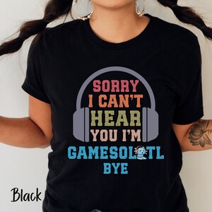 May include: Black t-shirt with a graphic of headphones and the text "Sorry I can't hear you I'm gamesol'n tl bye".