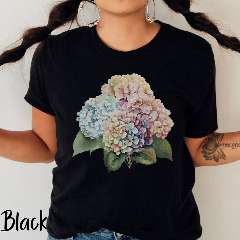 May include: Black t-shirt with a colorful floral print of hydrangeas. The flowers are in shades of pink, blue, and white.