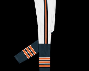 May include: Full-length leggings featuring a white upper section with a vertical navy blue and orange stripe. The lower section is navy blue with three horizontal orange stripes near the ankle. The fabric is smooth and fitted with a high waistband.