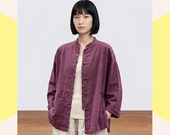 May include: A deep plum-colored long-sleeved jacket featuring a mandarin collar, five fabric-covered toggle closures down the front, and two large patch pockets on the lower front. The jacket has a relaxed fit with cuffed sleeves.