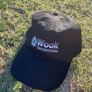 May include: Black baseball cap with a white embroidered sun and the text "Wook Tendencies".
