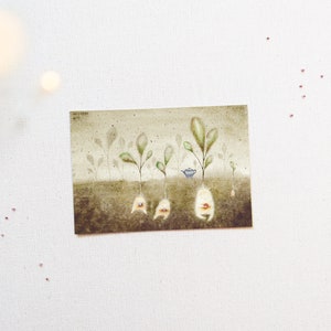 May include: A watercolour painting of five small, green plants with white roots and faces. The plants are growing in brown soil. A small blue teapot sits between two of the plants.