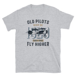 May include: Grey t-shirt with a vintage aeroplane graphic and the text "Old Pilots Never Die They Just Fly Higher".
