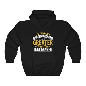 May include: Black hooded sweatshirt with a gold graphic that reads "The Comeback Is Always Greater Than The Setback".