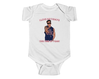 May include: White baby onesie with a pink graphic of a man wearing a blue tank top and sunglasses. The graphic says "I love birthdays this time of year!"