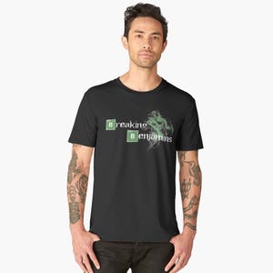 May include: A black t-shirt with a white graphic that says "Breaking Benjamins" with two green "B" squares.