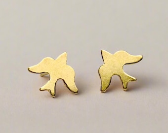 May include: A pair of gold-toned bird-shaped stud earrings. The earrings are small and delicate, and they would make a great gift for someone who loves birds.