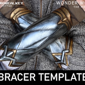 May include: A pair of silver and gold Wonder Woman bracers with a diamond pattern. The bracers are crossed over each other and are resting on a gray knitted fabric. The text "BRACER TEMPLATE" is at the bottom of the image.