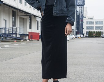 May include: A black velvet skirt with a denim jacket. The skirt is knee-length and has a straight silhouette.