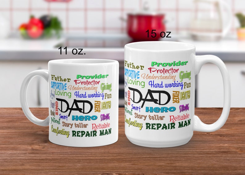 May include: White ceramic coffee mug with a word cloud design featuring the word "DAD" in black and other words in various colors, including "Father", "Provider", "Hero", "Repair Man", and "Story Teller". The mug is available in two sizes: 11 oz and 15 oz.