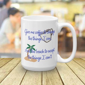 May include: White ceramic coffee mug with a blue and black graphic that reads "Give me coffee to change the things I can and the beach to accept the things I can't".