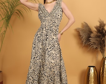 Bohemian print maxi dress with gold highlights | Ethnic polyester dress with paisley pattern | Flowy beige dress with black patterns