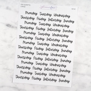 May include: A sheet of planner stickers with the days of the week written in a handwritten font. The days of the week are repeated multiple times on the sheet. The stickers are white with black lettering. The text "DAY SCRIPTS LARGE" and "plannerface" are at the top of the sheet. The text "M141" is at the top right of the sheet.