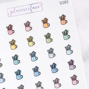 May include: A sheet of planner stickers with illustrations of pencils in mugs. The stickers are in various colours, including pink, orange, yellow, green, blue, and purple. The text "plannerface" is in the upper left corner.