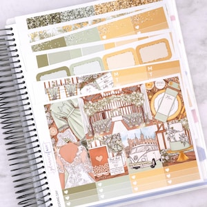 May include: A planner with wedding-themed stickers. The stickers feature illustrations of a wedding dress, cake, and a vintage van. The colour palette includes shades of green, gold, and white. The planner is spiral-bound and includes the text "Wedding Day".