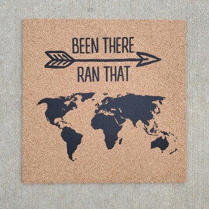 May include: Corkboard with a world map and the text "Been there, ran that" with an arrow pointing to the right.