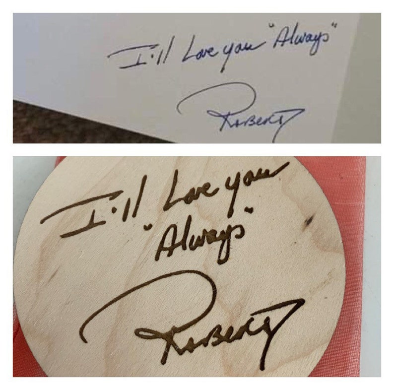 May include: A close-up of a wooden circle with the words "I'll love you Always" and a signature. The circle is on a pink surface.
