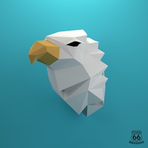 May include: A white origami bald eagle head with a yellow beak. The eagle is facing to the left and is set against a blue background.