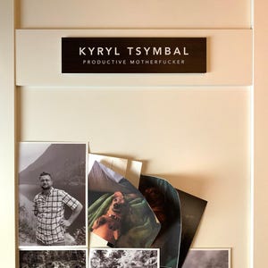 a collection of photographs, including a black and white image of a man, a black and white image of a dog, and a black and white image of a mountain. The name 'Kyryl Tsymbal' is displayed above the photographs.