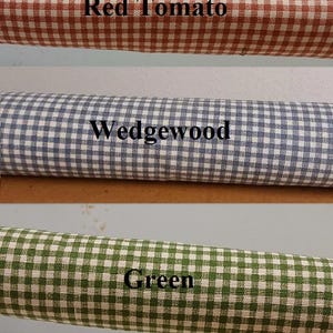 May include: Three fabric rolls with a gingham pattern in red, blue, and green. The red roll is labeled "Red Tomato", the blue roll is labeled "Wedgewood", and the green roll is labeled "Green".