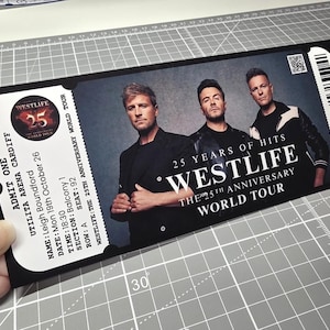 May include: Black Westlife concert ticket for the 25th Anniversary World Tour, featuring the band's image. The ticket shows details for the Cardiff show, with the text "25 Years of Hits" and a barcode.