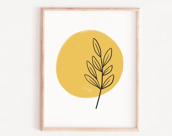 May include: A minimalist art print featuring a simple black line drawing of a branch with leaves on a yellow circle background. The print is framed in a light wood frame.