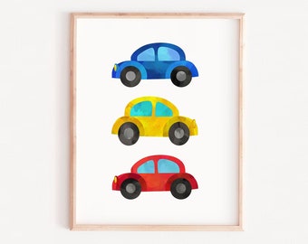 May include: A framed print with three watercolor cars in a row. The top car is blue, the middle car is yellow, and the bottom car is red. The print has the text "ART PRINTS FACTORY" at the bottom.