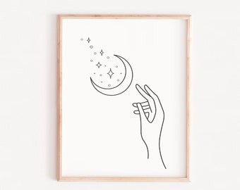 以下が含まれることがあります： 星がついた三日月に向かって手を伸ばしている手の線画プリント。プリントは白黒で、ミニマルな美しさです。
