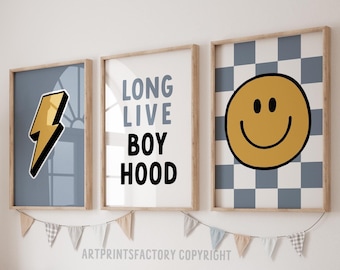 May include: Three framed prints with a blue and white checkered background. The prints feature a yellow lightning bolt, the text "LONG LIVE BOYHOOD", and a yellow smiley face.