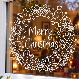 May include: A white window decal featuring a circular wreath design with the text Merry Christmas in the center. The wreath is composed of cartoon-style illustrations of a star, a tree, a candy cane, a gingerbread person, and an ornament.