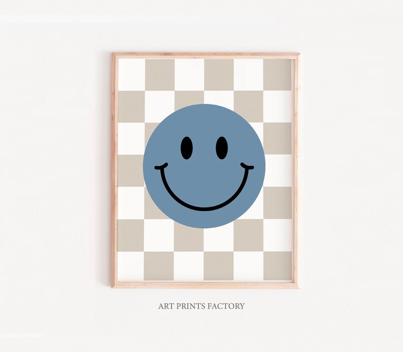 May include: A blue smiley face on a beige and white checkered background. The image is framed with a light wood frame. "ART PRINTS FACTORY" is printed below the image.