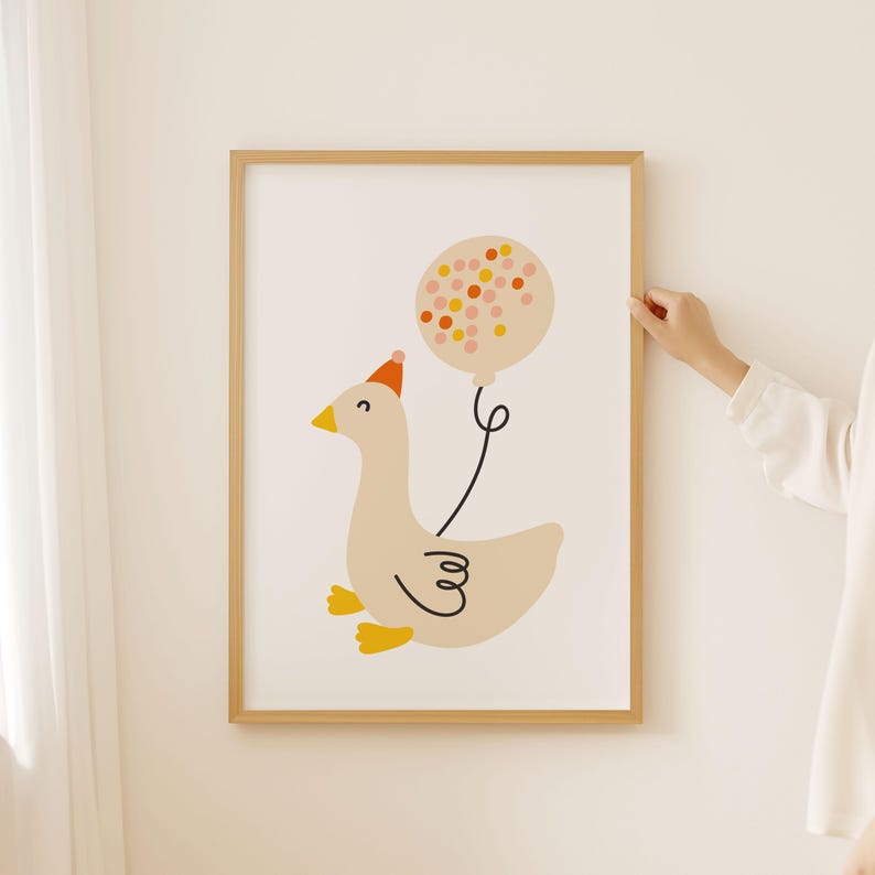 May include: A framed print of a cartoon goose wearing a party hat and holding a pink and orange polka dot balloon.