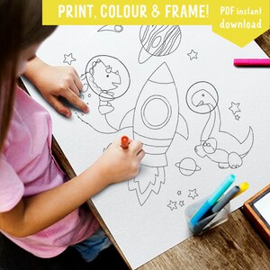 May include: A black and white printable coloring page featuring a rocket, two dinosaurs, stars, and planets.  The page is titled "PRINT, COLOUR & FRAME! PDF instant download".