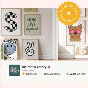 May include: A collection of framed wall art prints featuring a checkered letter S, a Long Live Boyhood sign, a blue smiley face, a peace sign hand gesture, a dog with heart-shaped glasses, and hands forming a heart shape, displayed on a wall.