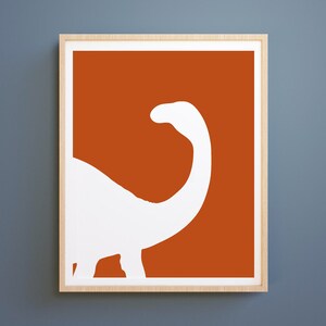 May include: A white silhouette of a dinosaur on a burnt orange background. The dinosaur is facing left and has a long neck.